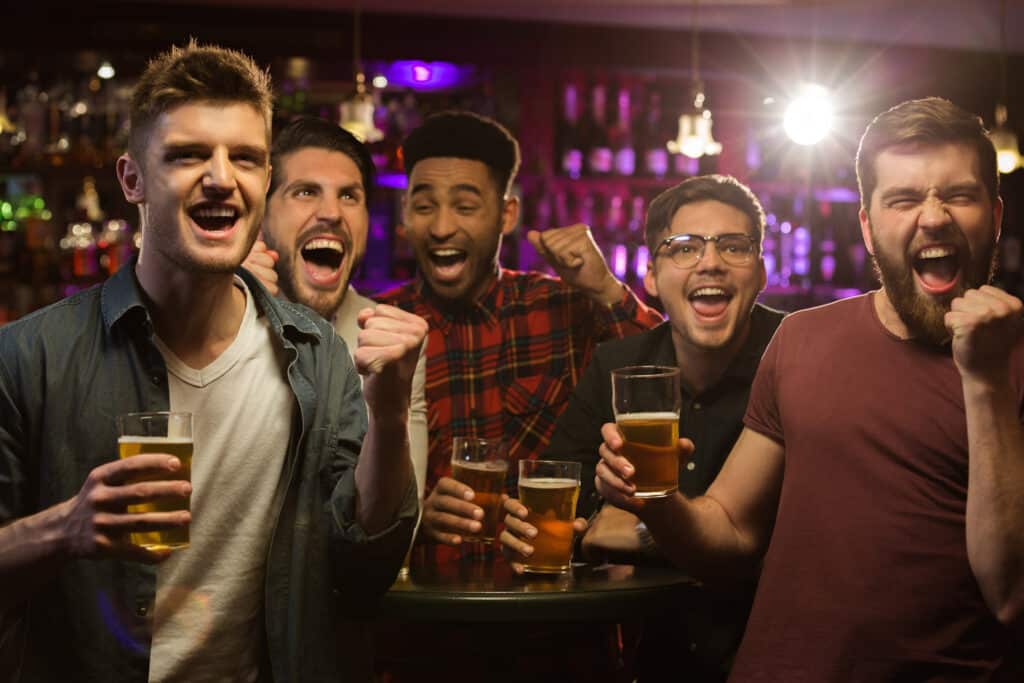Men celebrating at an axe throwing bachelor party