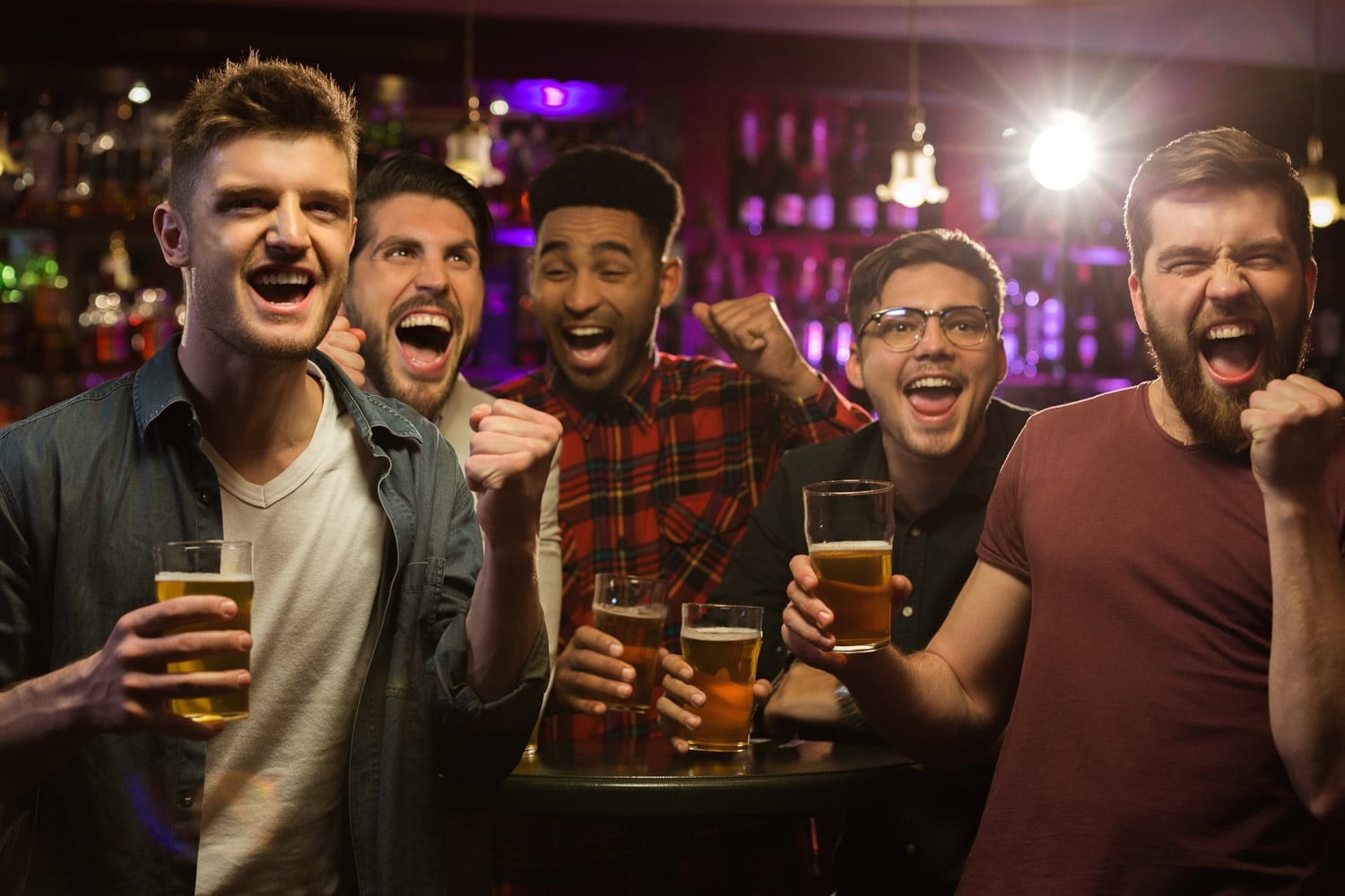 Men celebrating at an axe throwing bachelor party