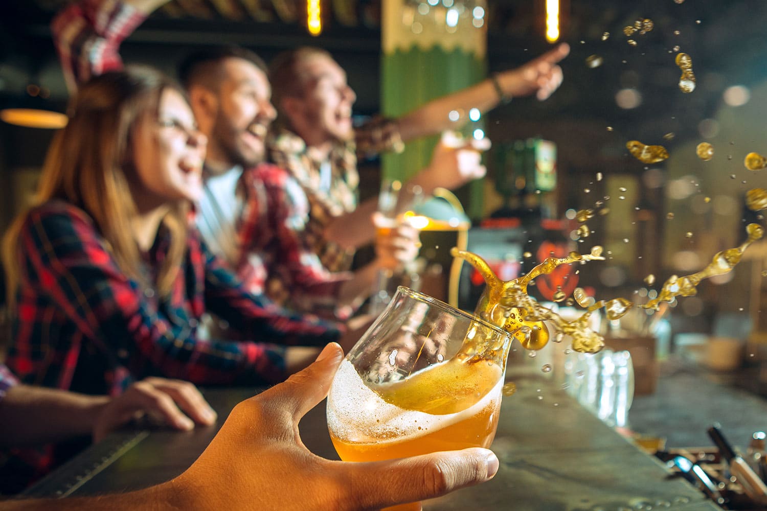 People cheering and having drinks at a bar