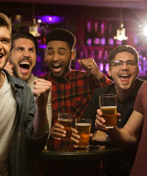 Men celebrating at an axe throwing bachelor party